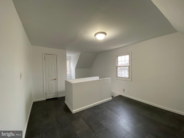 bonus room featuring dark hardwood / wood-style floors and vaulted ceiling