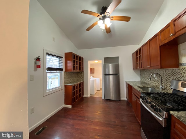 kitchen featuring sink, stainless steel appliances, light stone counters, dark hardwood / wood-style flooring, and decorative backsplash