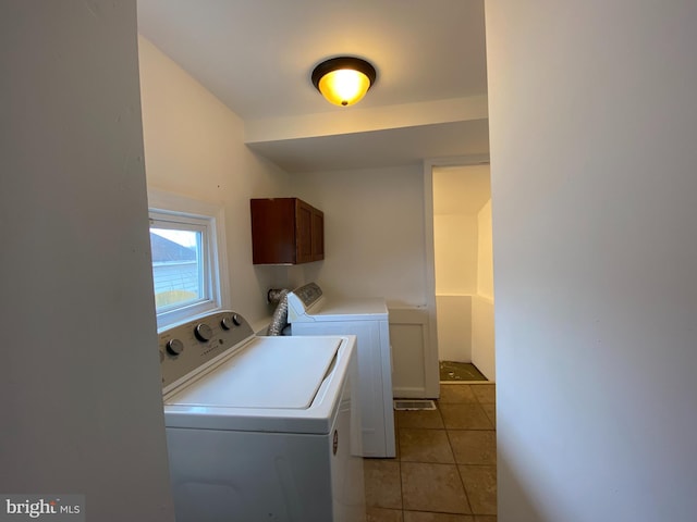 washroom with washing machine and clothes dryer and light tile patterned flooring