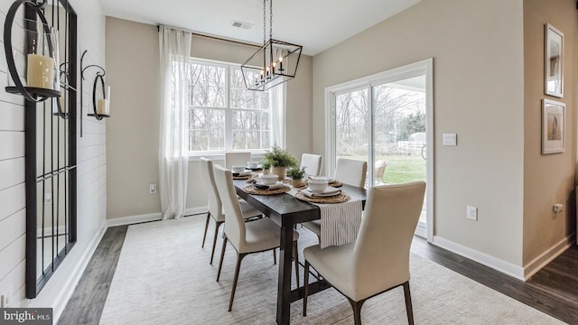 dining area featuring dark hardwood / wood-style flooring and a notable chandelier