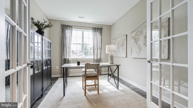 office with french doors and dark hardwood / wood-style flooring