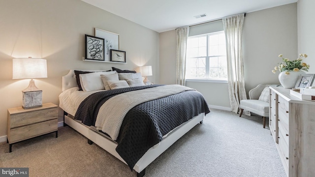 bedroom featuring light colored carpet