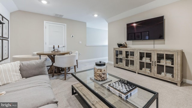 carpeted living room featuring lofted ceiling