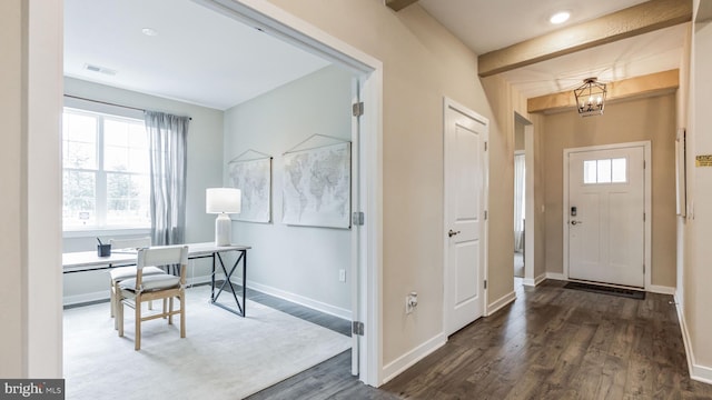 entrance foyer with dark hardwood / wood-style flooring and an inviting chandelier