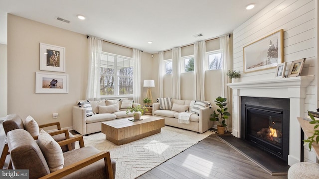 interior space featuring a large fireplace and light hardwood / wood-style flooring