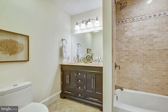 full bathroom with toilet, tile patterned floors, tiled shower / bath, and vanity