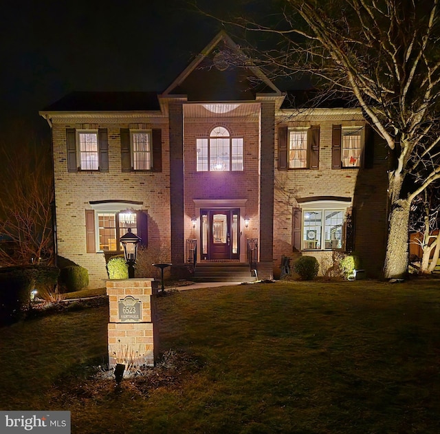 view of front of property with a yard