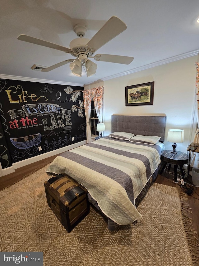 bedroom featuring ceiling fan, ornamental molding, and hardwood / wood-style flooring