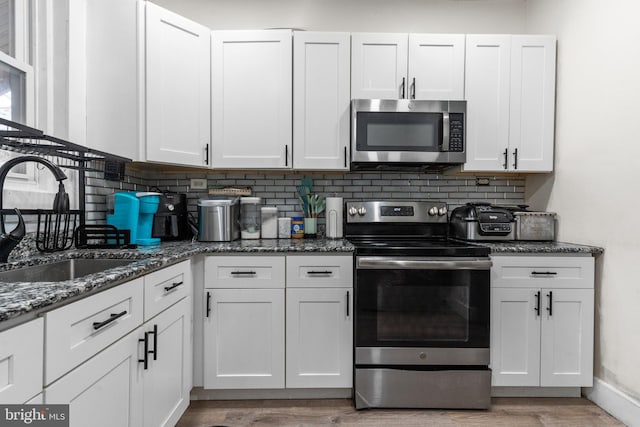 kitchen featuring white cabinetry, sink, and appliances with stainless steel finishes