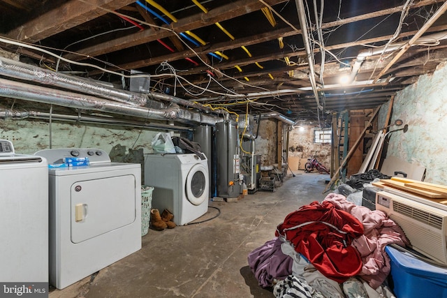 basement featuring water heater and washer and dryer