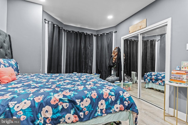 bedroom featuring hardwood / wood-style floors and a closet