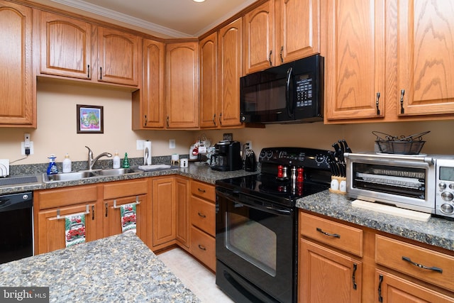 kitchen with sink, dark stone countertops, light tile patterned flooring, black appliances, and ornamental molding