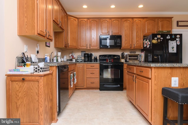 kitchen with black appliances, sink, and crown molding