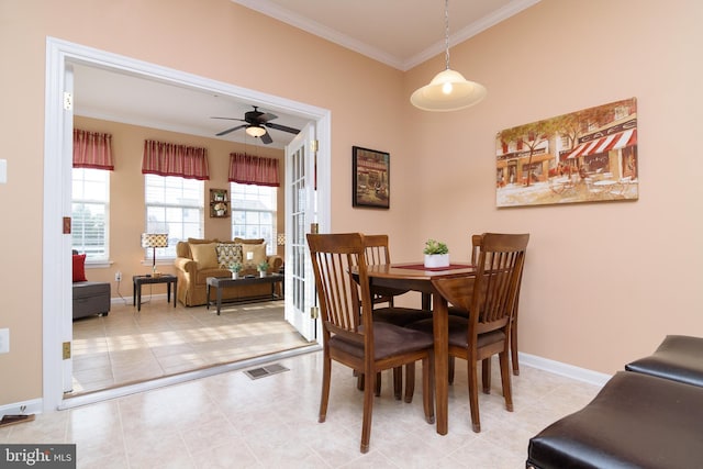 dining room with ceiling fan and crown molding