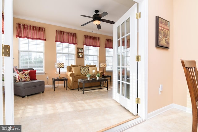 sitting room featuring tile patterned floors, ceiling fan, and ornamental molding