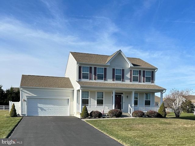 colonial home with a front lawn, a porch, and a garage