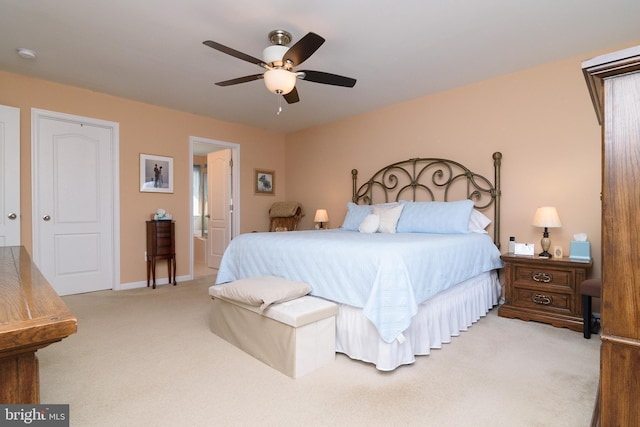 bedroom with carpet, ceiling fan, and ensuite bathroom