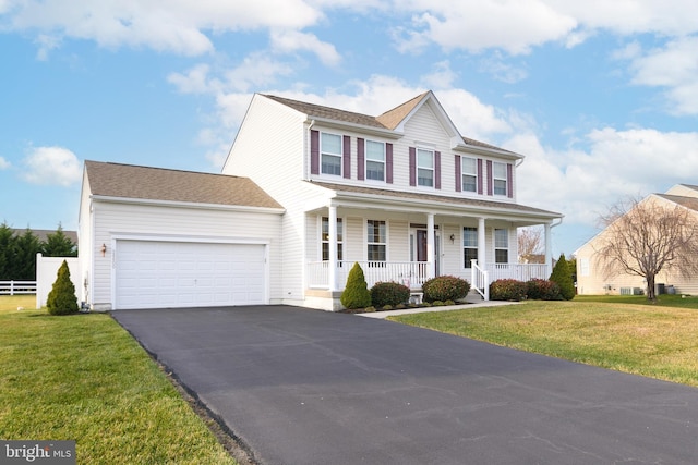 colonial-style house with a front yard, a porch, and a garage