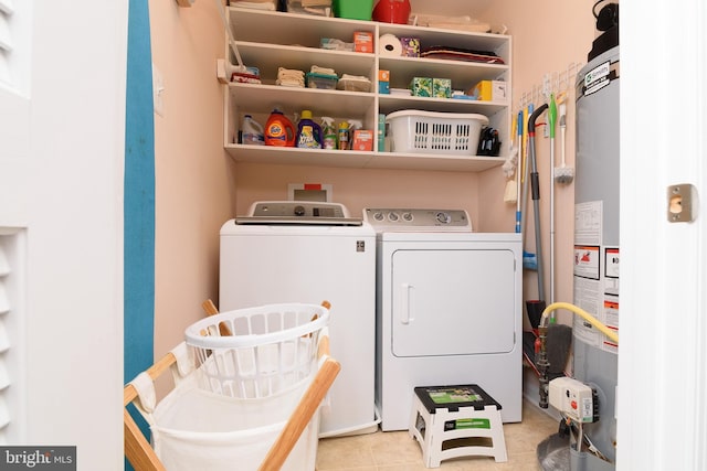 laundry area featuring washer and dryer and light tile patterned flooring