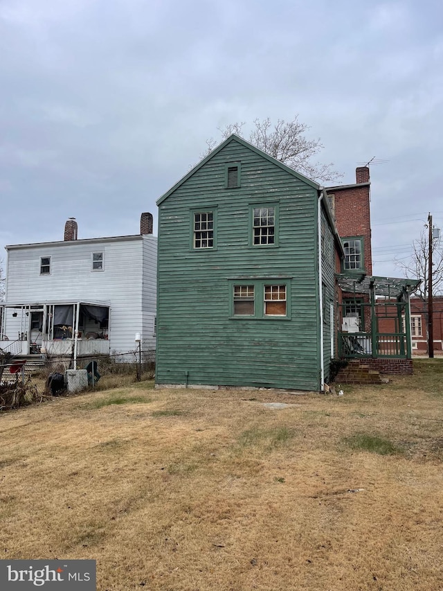 rear view of house with a lawn