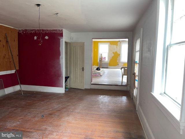 interior space featuring hardwood / wood-style flooring and radiator heating unit