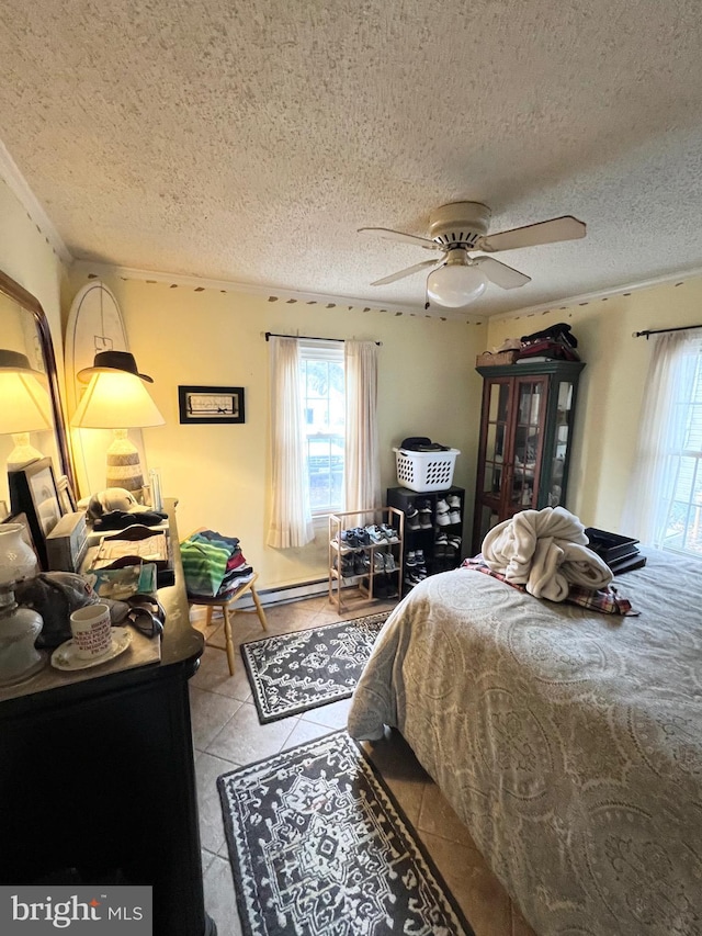 tiled bedroom with ceiling fan and a textured ceiling