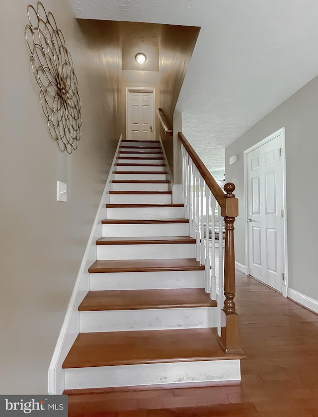 stairway with wood-type flooring