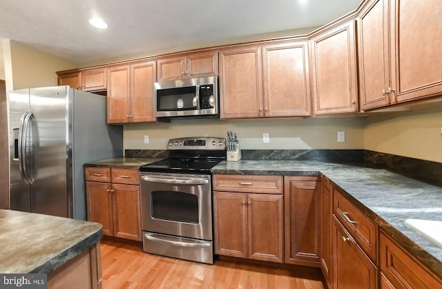 kitchen featuring stainless steel appliances and light wood-type flooring