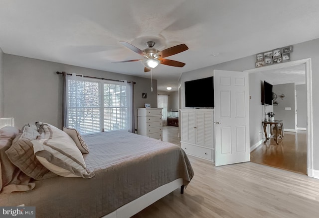 bedroom featuring light hardwood / wood-style flooring and ceiling fan