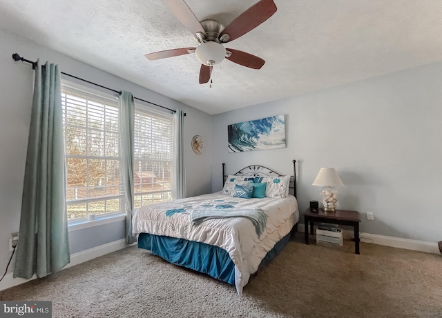 bedroom featuring carpet flooring, ceiling fan, and a textured ceiling