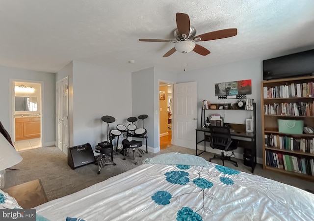 bedroom with connected bathroom, ceiling fan, light colored carpet, and a textured ceiling