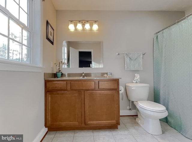 bathroom featuring toilet, vanity, tile patterned floors, and walk in shower