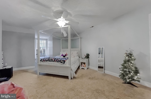 carpeted bedroom with ceiling fan and a textured ceiling