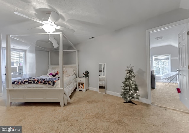 bedroom featuring multiple windows, carpet floors, ceiling fan, and lofted ceiling