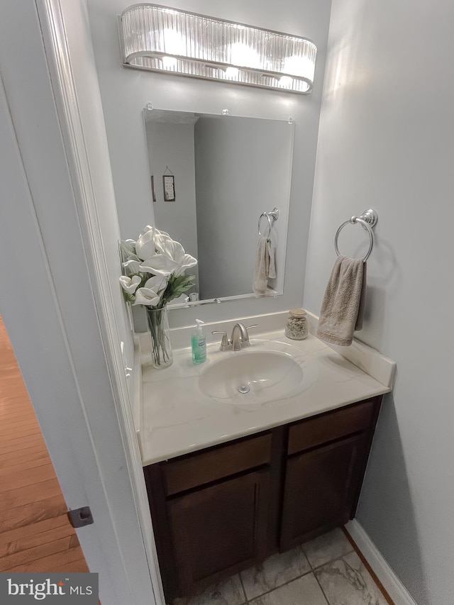 bathroom with hardwood / wood-style floors and vanity