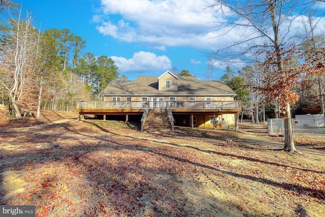 back of house with a deck