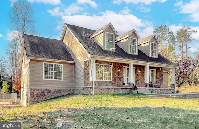 cape cod home featuring a porch and a front yard