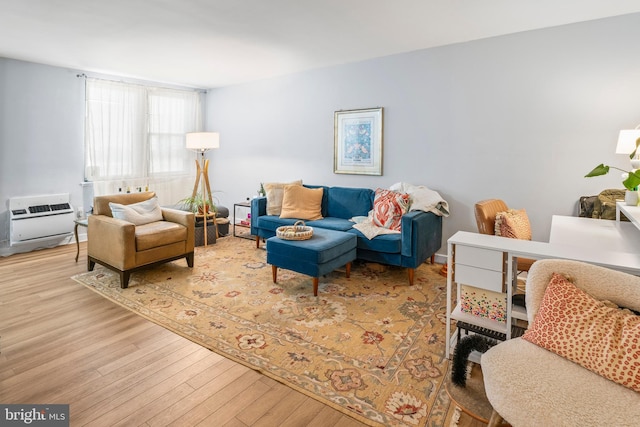 living room with heating unit and light hardwood / wood-style flooring