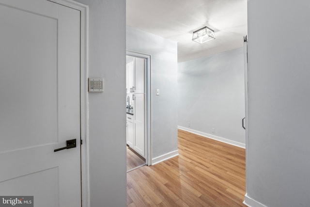 corridor with light wood-type flooring