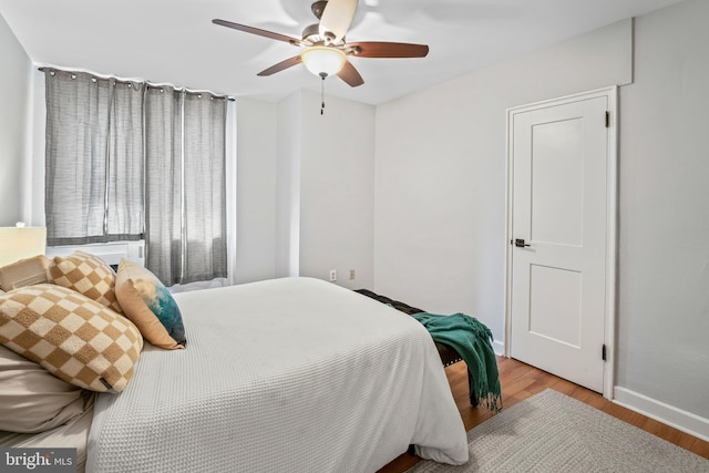 bedroom with ceiling fan and light wood-type flooring