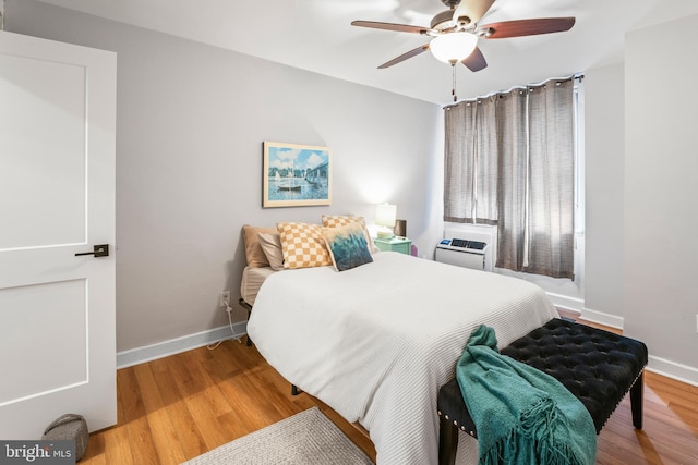 bedroom with ceiling fan and wood-type flooring