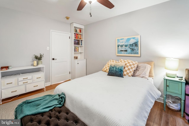 bedroom featuring ceiling fan and dark hardwood / wood-style floors