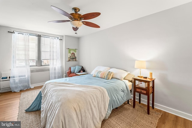 bedroom with light hardwood / wood-style flooring and ceiling fan