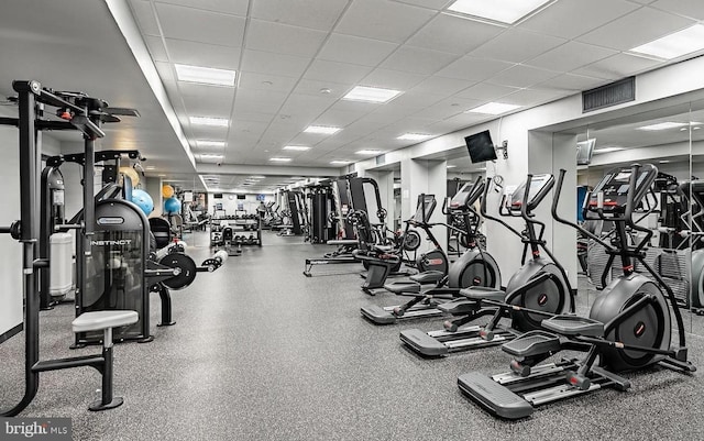 gym with a paneled ceiling