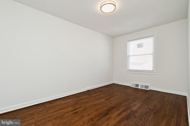 spare room featuring dark hardwood / wood-style flooring