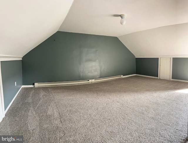 additional living space with carpet, lofted ceiling, and a baseboard heating unit