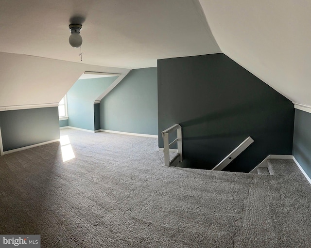 additional living space with carpet flooring and lofted ceiling