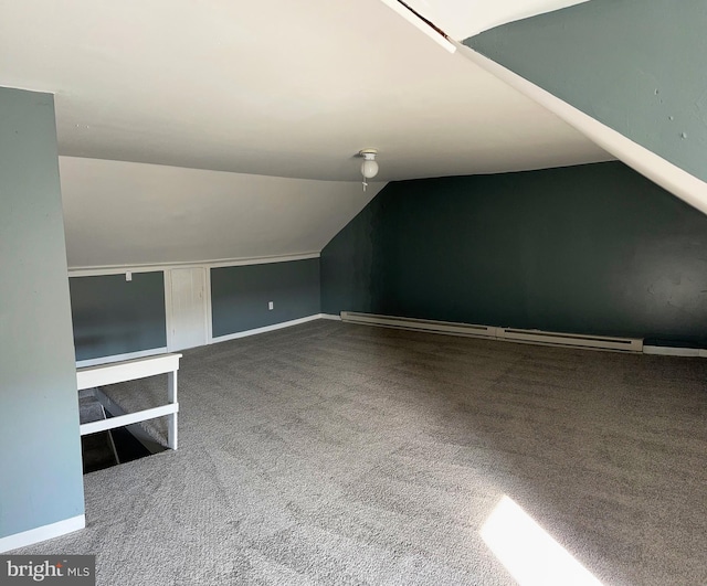 bonus room featuring a baseboard heating unit, carpet floors, and vaulted ceiling