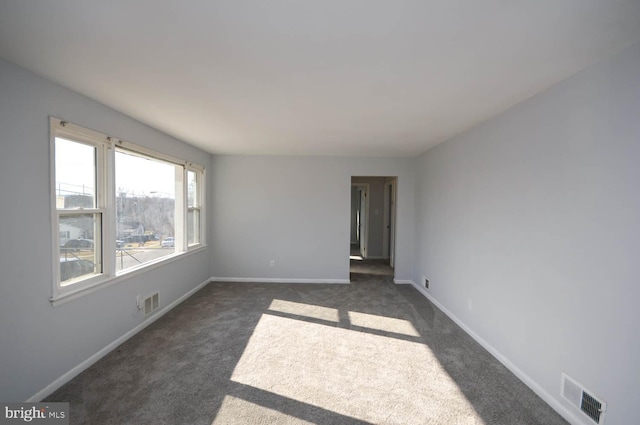 empty room featuring dark carpet