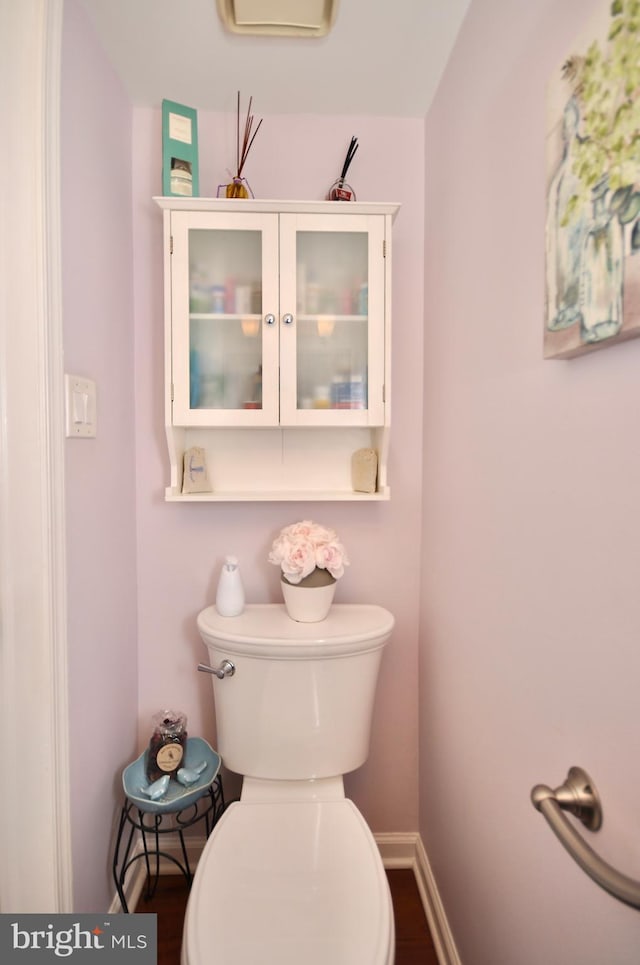 bathroom with a wall mounted air conditioner and toilet